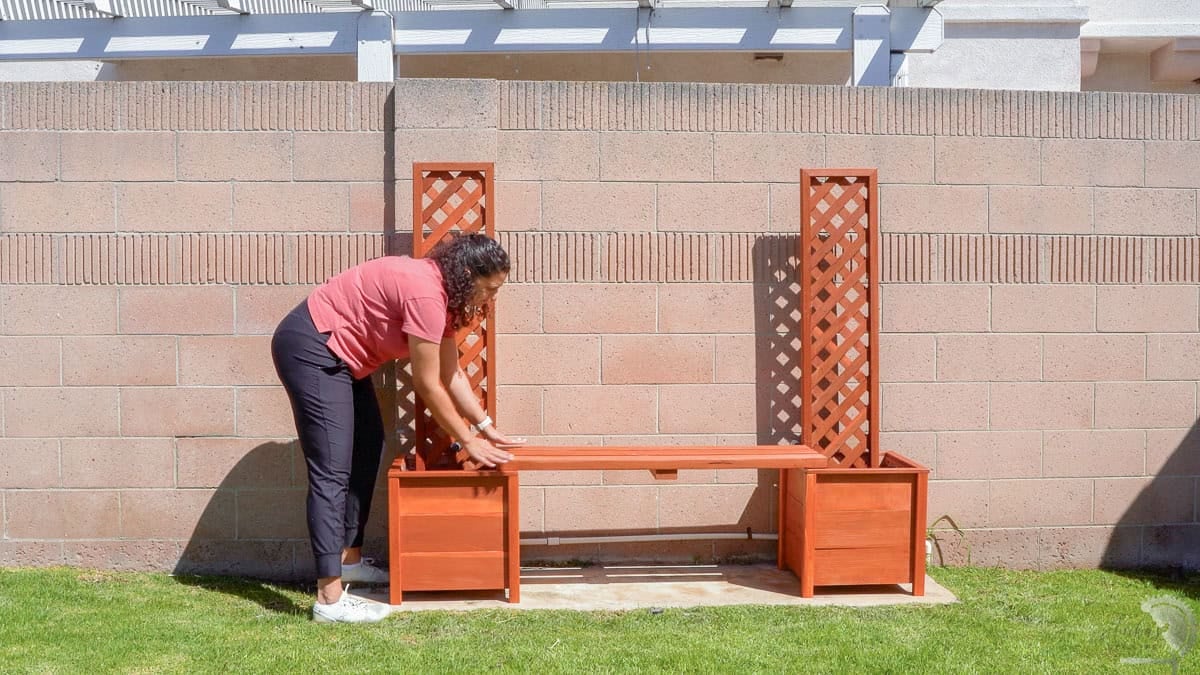 Installing the planter bench in the backyard