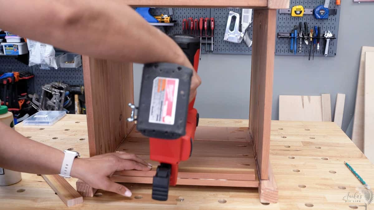 Attaching the ledge for the bottom of the planter using a nail gun