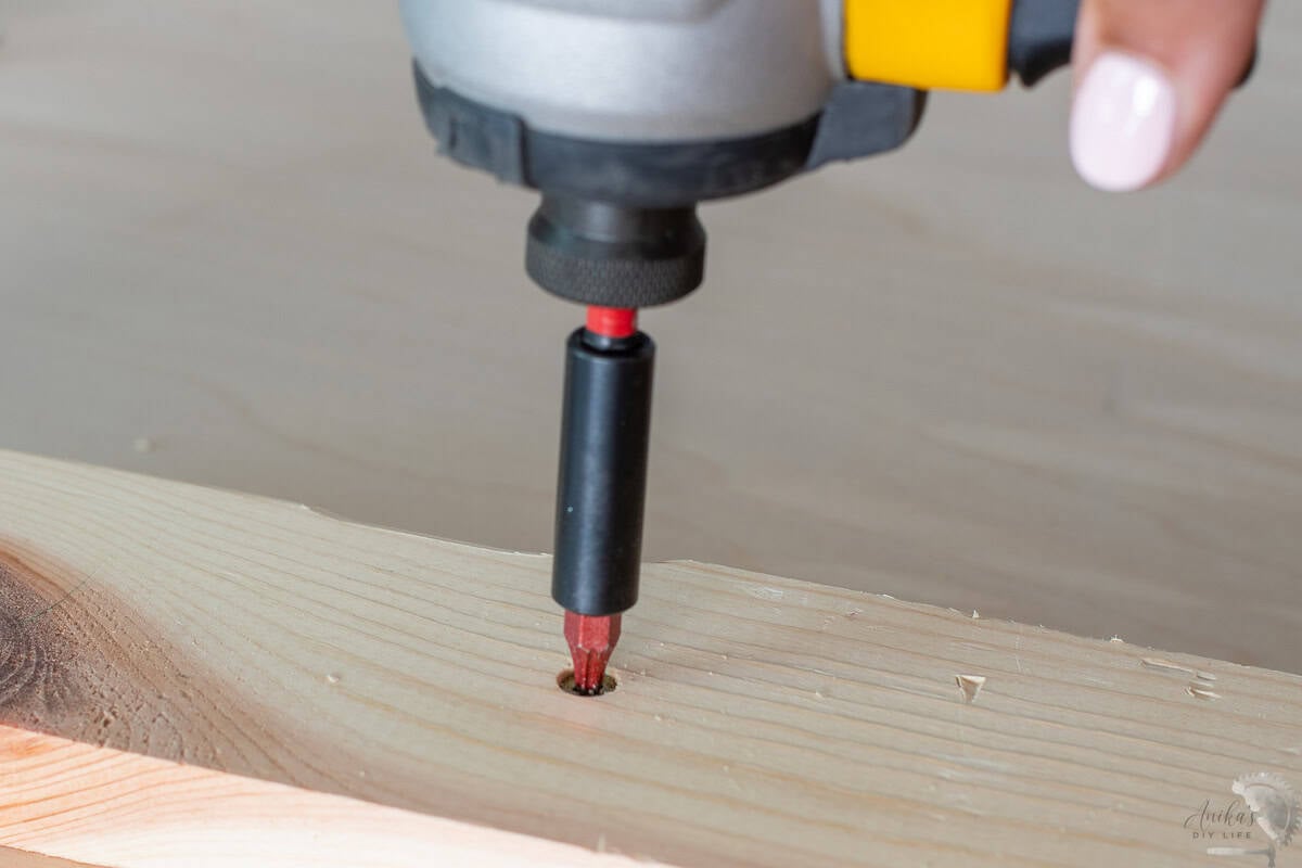 adding a self countersinking screw to the wood.