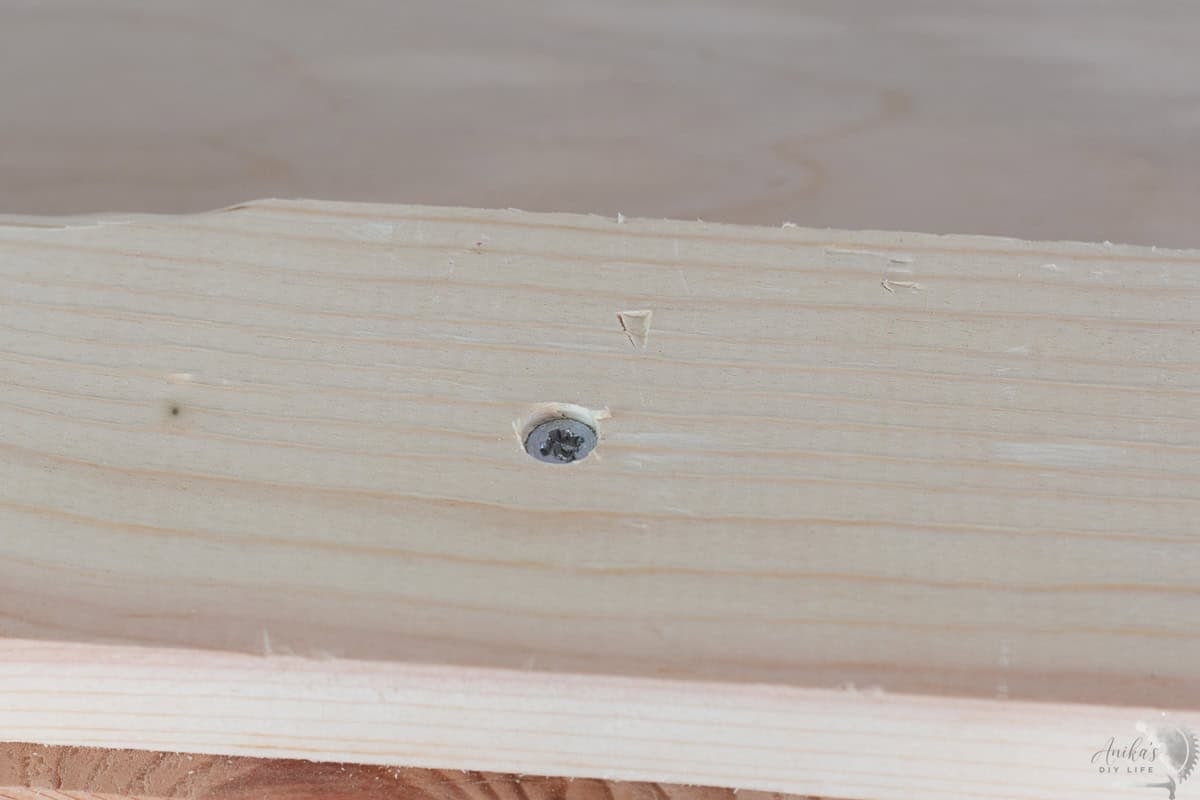 countersunk screw driven into wood in the countersunk hole.