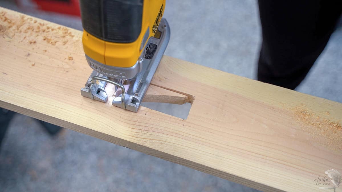 Cutting a hole with a jigsaw for the power strip for the DIY sofa table with charging