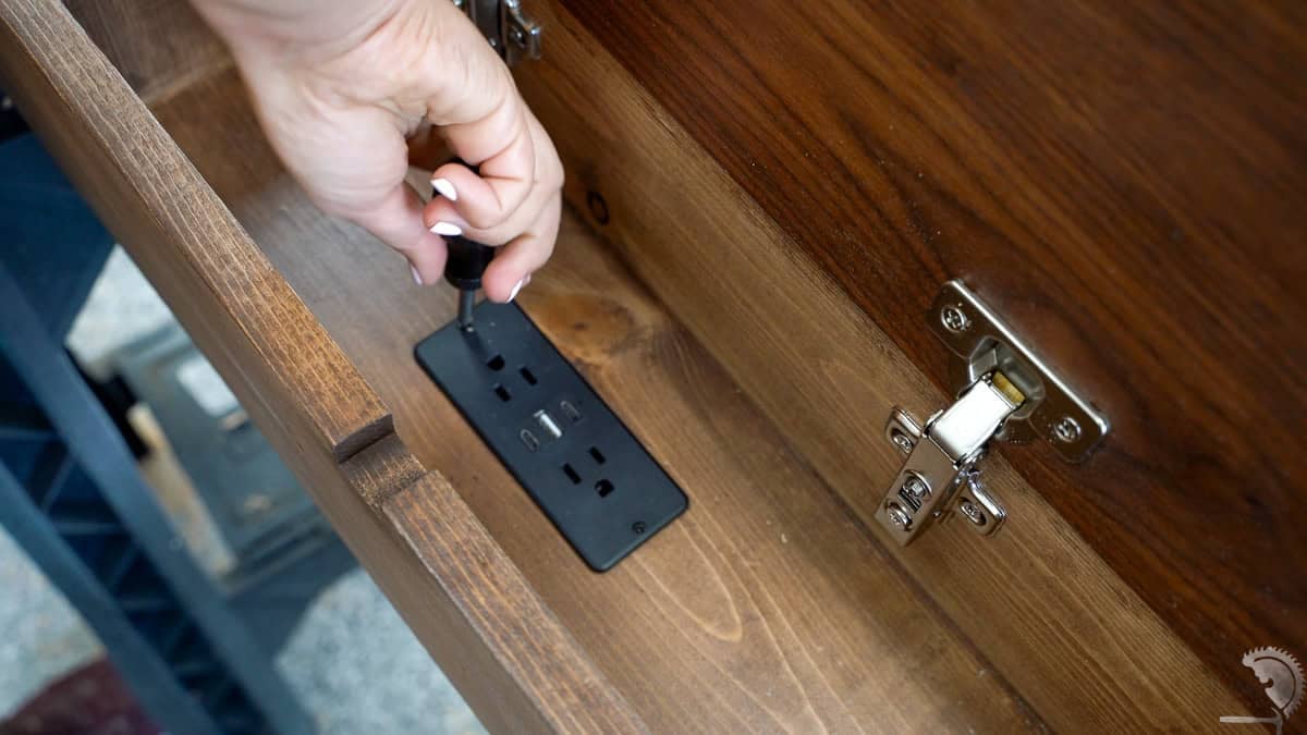 Attaching the power strip to the diy sofa table.