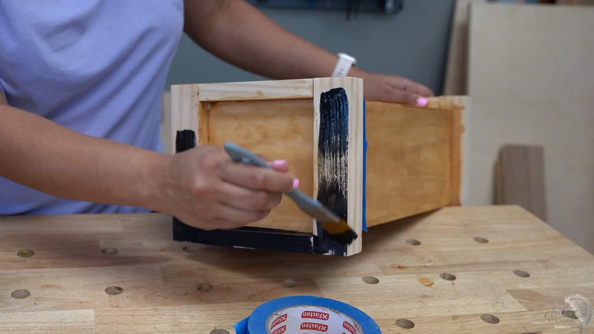 applying black paint