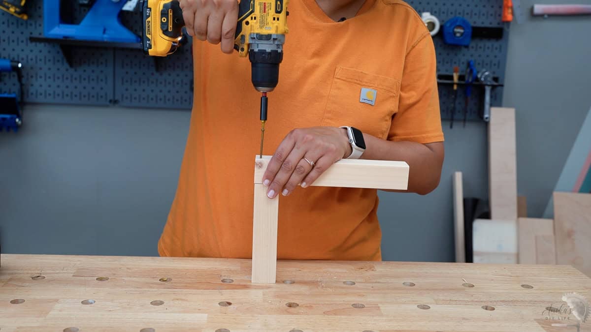 building the bottom and top of the house shaped lantern using wood screw.
