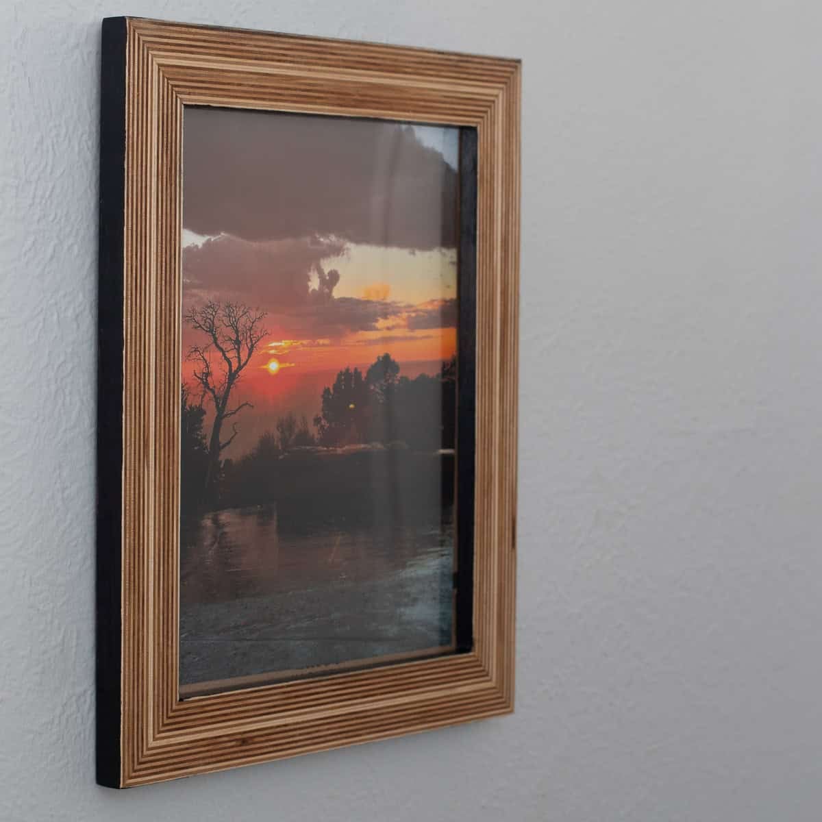 Learn how to build a stunning DIY plywood picture frame that highlights the stacked wood edges. It’s the perfect handmade gift.