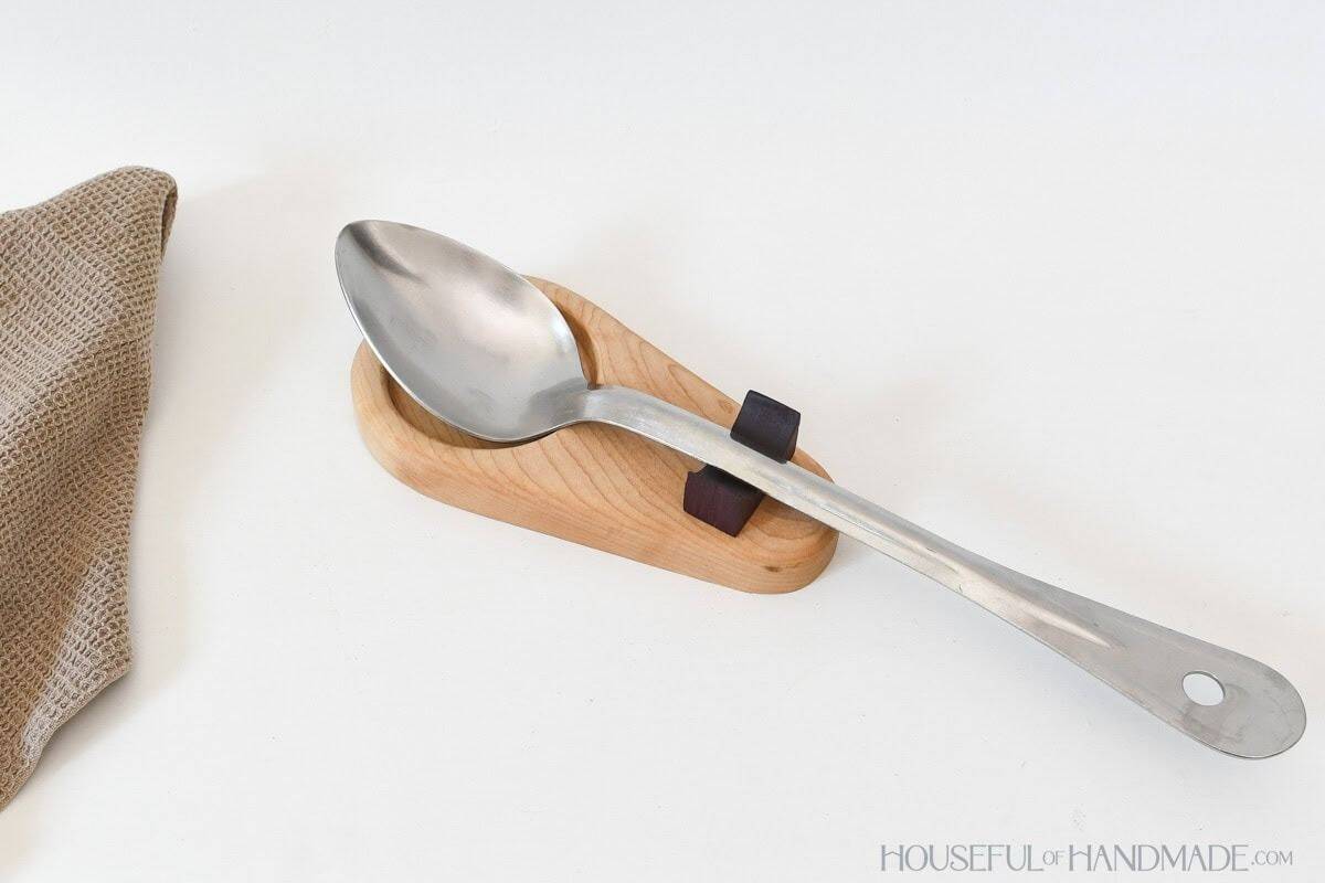 Wood spoon rest with spoon on counter. Handmade gift idea