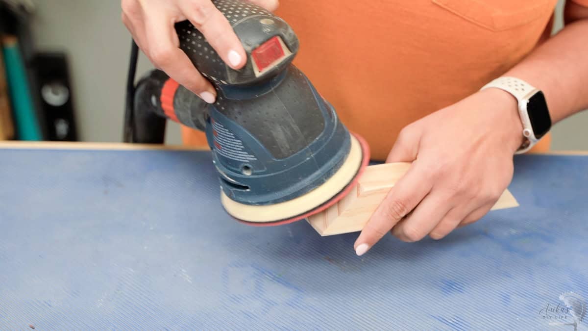 Sanding a wood block with a bosch sander